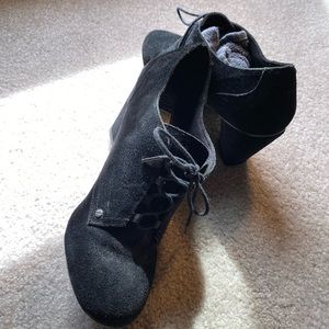 Black suede bootie with three inch heel.